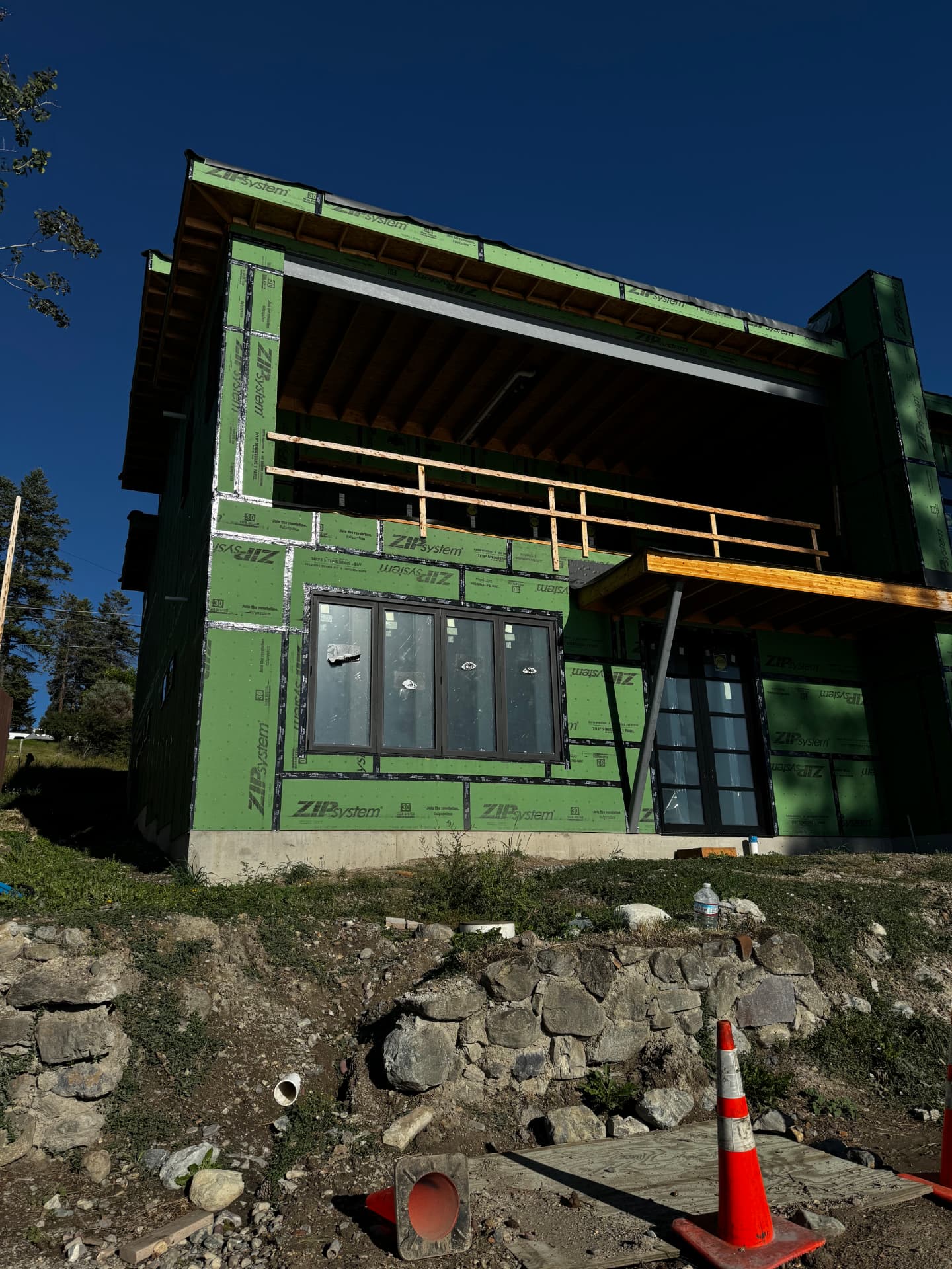 Hillside new build with taped sheathing ready for stucco lath in Whitefish, MT