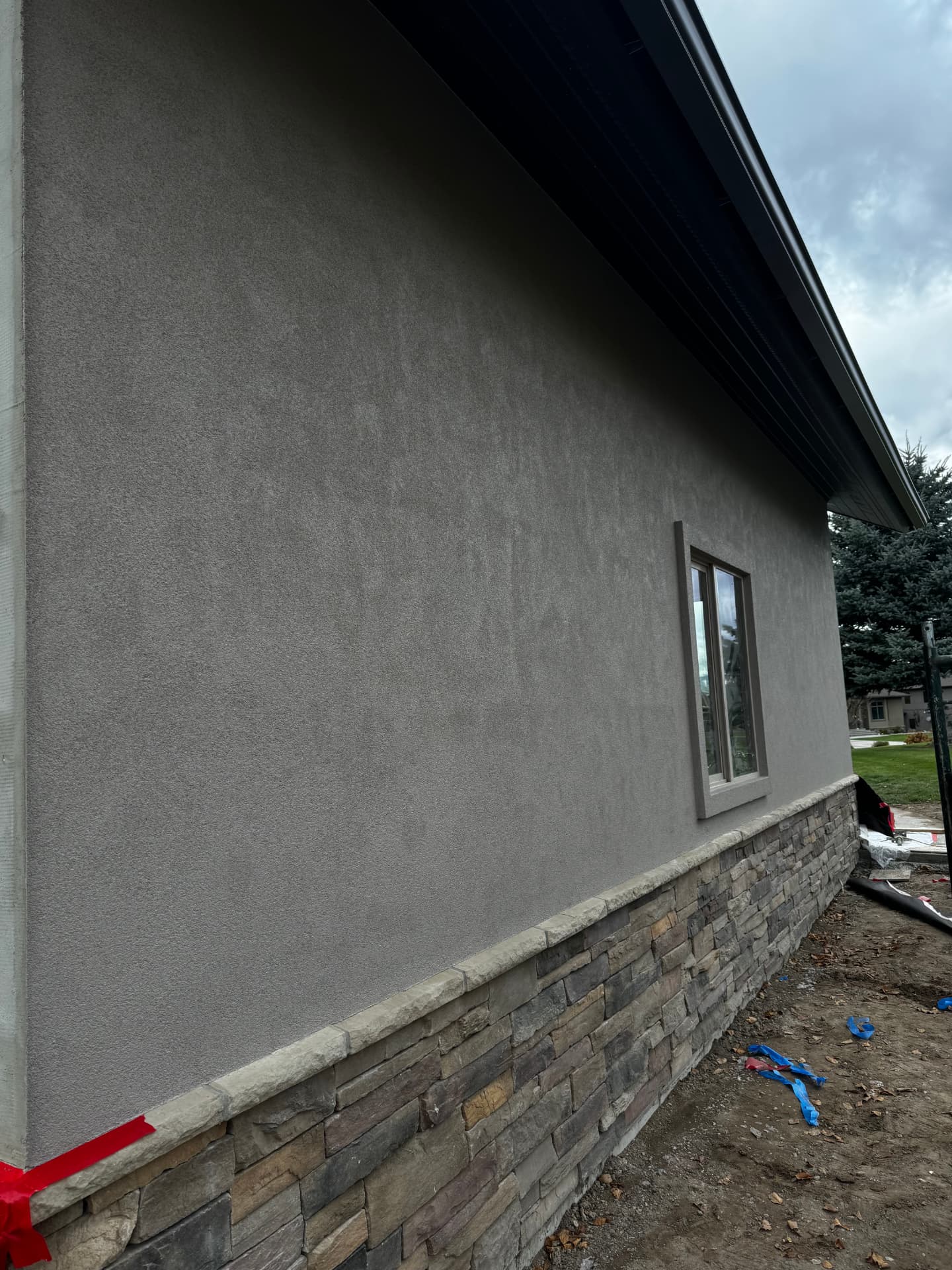 Mixed-Material Lake View Exterior — Stucco & stone · Bigfork by DL Construction