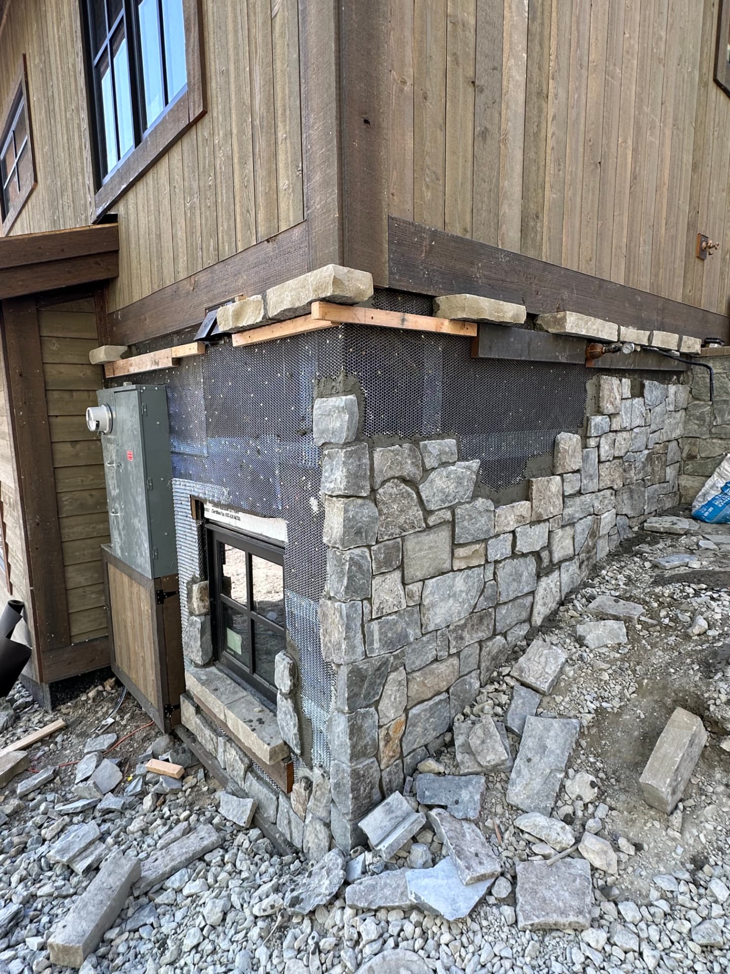Snow-Line Stone Base Detailing — Stone & moisture detailing · Whitefish by DL Construction