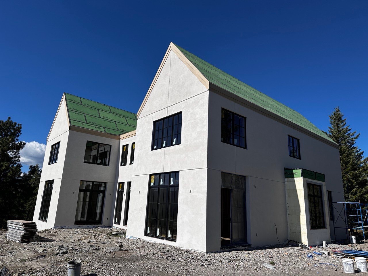 Custom Kalispell, MT home with warm stucco walls and natural stone veneer accents